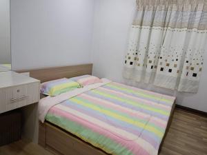 a small bedroom with a bed and a window at Best Sekinchan homestay in Sekincan