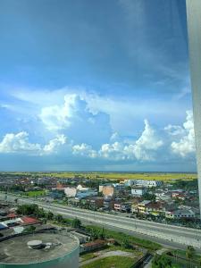 an aerial view of a city with a highway at Best Sekinchan homestay in Sekincan