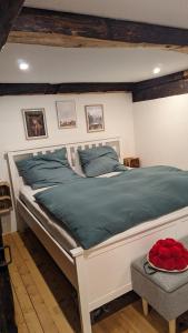 ヴィーデンにあるFerienwohnung im Historischen Schwarzwaldhausのベッドルーム(青い枕の大きな白いベッド付)