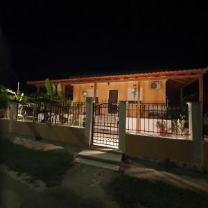 a house with a gate in front of it at night at Villa Sunny Day Riviera in Asprovalta