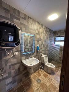 uma casa de banho com um lavatório, um WC e uma televisão em 6/ Antica jabalal-lwebdeh em Amã