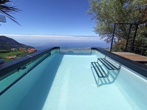 a swimming pool with a view of the ocean at Vistas Del Valle; piscina, wifi bbq... in Santa Cruz de Tenerife