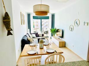 sala de estar con mesa de madera y sillas en Apartamento con Piscina y Jardín Fantástico Cala Sirenas - Nuevo, en Miami Platja