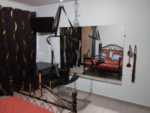 a swing in a room with a picture of a bed at Loveroom avec siège massant et spa in Cayenne