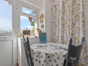 a dining room with a table and chairs and a window at The Cwtch in Pembrokeshire