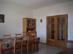 a dining room with a table and a wooden cabinet at Appartement Font-Romeu-Odeillo-Via, 5 pièces, 9 personnes - FR-1-580-37 in Font-Romeu-Odeillo-Via