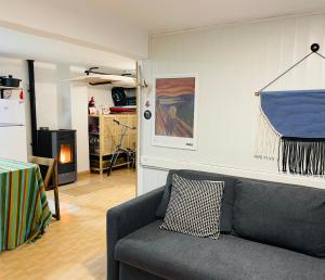 a living room with a gray couch and a fireplace at Apto Bakio a pie de playa in Bakio