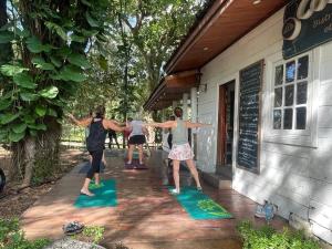 a group of people doing yoga outside of a building at Cozy family house with pool in Atenas
