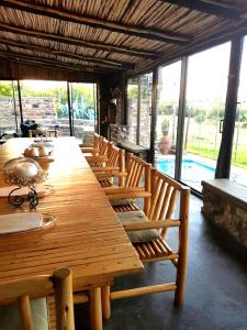 a long wooden table and chairs in a room at Suites in Private Game Reserve close to Aliwal North in Gladdegrond
