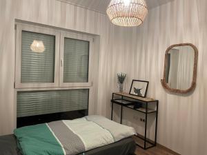 a bedroom with a bed and a large mirror at Komfort Deluxe am Airport Weeze in Weeze