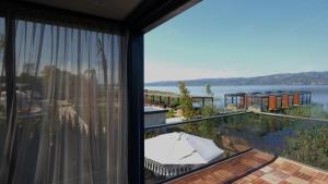 a view of the water from a house with a balcony at Velour Hotel Spa Restaurant in Sakarya