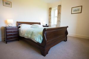 a bedroom with a bed and a dresser and a window at Exclusive Use Moor Grange Farm 13 Bedrooms in Buxton +10 photos