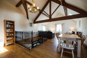 a living room with a table and a chandelier at Exclusive Use Moor Grange Farm 13 Bedrooms in Buxton
