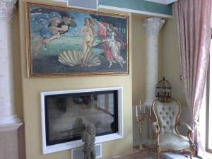 a living room with a fireplace and a painting on the wall at Apartments Anna on the Sunny beach in Sunny Beach