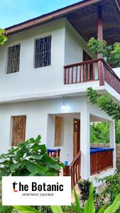 a house with a balcony in front of it at Villa de Flora Zanzibar 