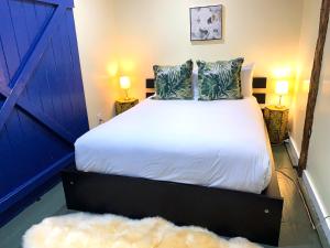 a bedroom with a bed with a blue door at Lotus Provincetown in Provincetown