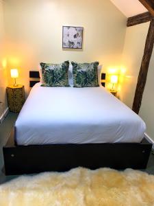 a bedroom with a large white bed with two lamps at Lotus Provincetown in Provincetown