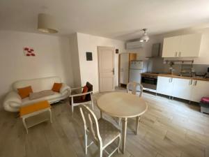 a living room with a table and a kitchen at Instant en Provence in Eyragues