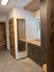 a room with wooden cabinets and a mirror at Ferienwohnung Sabine in Flattach