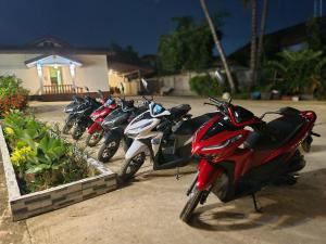 a row of motorcycles parked in a parking lot at Saphaothong guesthouse in Vang Vieng