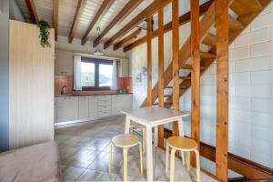 a kitchen with a table and two stools at Ageras Santa Marina in Lefkada