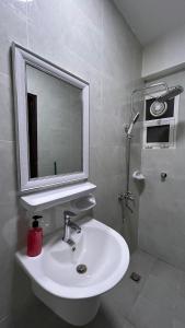 a bathroom with a white sink and a mirror at Basil Hostel in Muscat