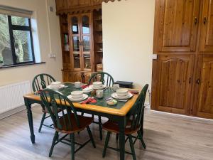 a dining room table with chairs and a table and a table and chairsuggest at An Cnoc in Killorglin
