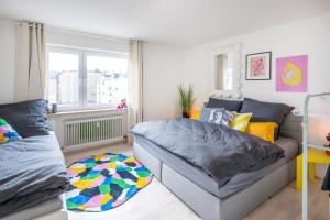 a living room with a couch and a bed at Pop Art Loft über den Dächern von Koblenz in Koblenz