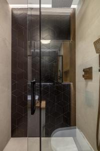 a shower with a glass door in a bathroom at Koźla Warsaw Old Town 1-Bedroom Superior Apartment WWA54 in Warsaw