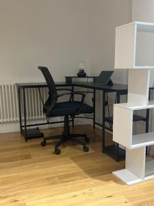 an office with a desk with a chair and a laptop at Huller and cheese warehouse apartments in Bristol