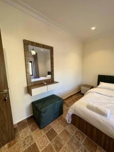 a hotel room with a bed and a mirror at 8/ Antica jabalal-lwebdeh in Amman