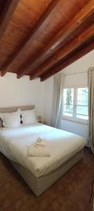 a bedroom with a large white bed in front of a window at Castle view in Veytaux