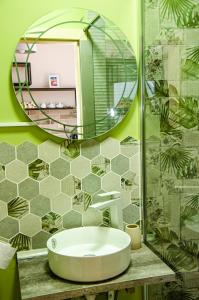 a bathroom with a white sink and a mirror at Sveti Nikola Family Hotel Sapareva Banya in Sapareva Banya