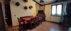 a dining room with a table and chairs and a television at Spritz's Home in Castel di Sangro