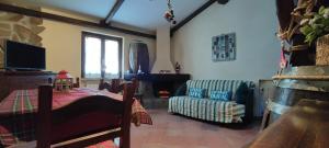 a living room with a couch and a chair at Spritz's Home in Castel di Sangro