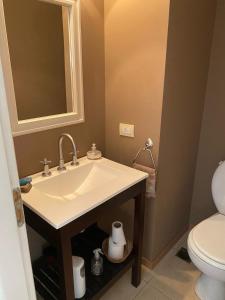 a bathroom with a sink and a toilet at Casa Las Margaritas II in San Carlos de Bariloche +16 photos