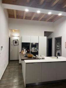 a kitchen with white cabinets and a white counter top at Villa di Carlone in Moscufo