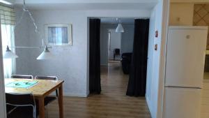 a kitchen with a table and a dining room with a table and chairs at Vojengården Lägenhet 3 in Ånge