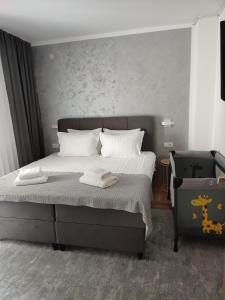 a bedroom with a bed with two towels on it at BorLu apartman in Đakovo