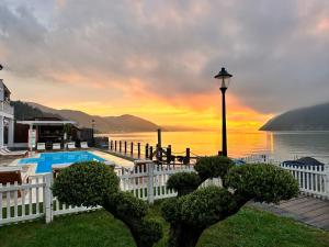 a resort with a pool and a sunset in the background at Serenity in Eşelniţa