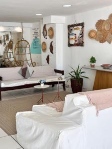 a room with two beds and a table at Pousada Seven in Arraial do Cabo
