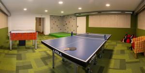 una sala de ping pong con mesa de ping pong en Auenhotel en Tux