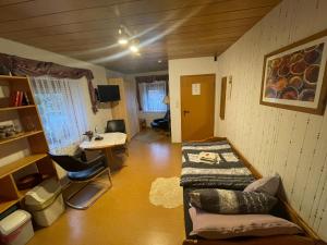 a room with a bed and a desk and a table at Ferienwohnung Hoffmann in Bad Münder am Deister