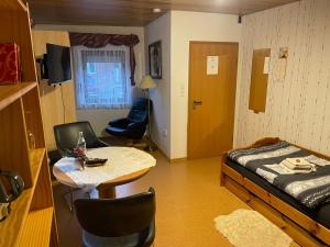 a bedroom with a bed and a table and chairs at Ferienwohnung Hoffmann in Bad Münder am Deister
