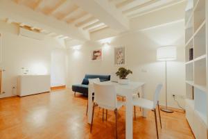 a living room with a table and a blue couch at Vista e Tetti ai Canacci in Florence