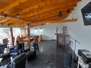 a person sitting in a living room watching a tv at Cabaña del Glaciar, al pie del glaciar vinciguerra zona ramsar in Ushuaia