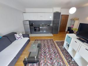 a living room with a couch and a kitchen at Boutique Apartments Daniela in Ohrid