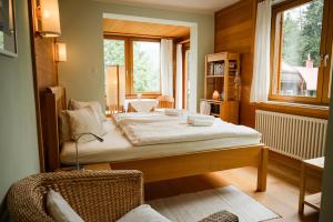a bedroom with a large bed and a window at Panoramahotel Wagner - Das Biohotel am Semmering in Semmering