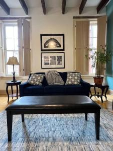 a living room with a blue couch in a room at Chic Two-Bedroom Apartment on Camp St, New Orleans in New Orleans