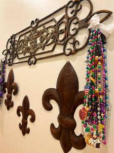 a wooden rack with beads on a wall at Chic Two-Bedroom Apartment on Camp St, New Orleans in New Orleans